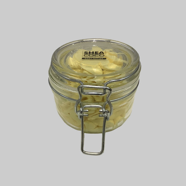 Jar of shea butter with a visible brand label on a gray background