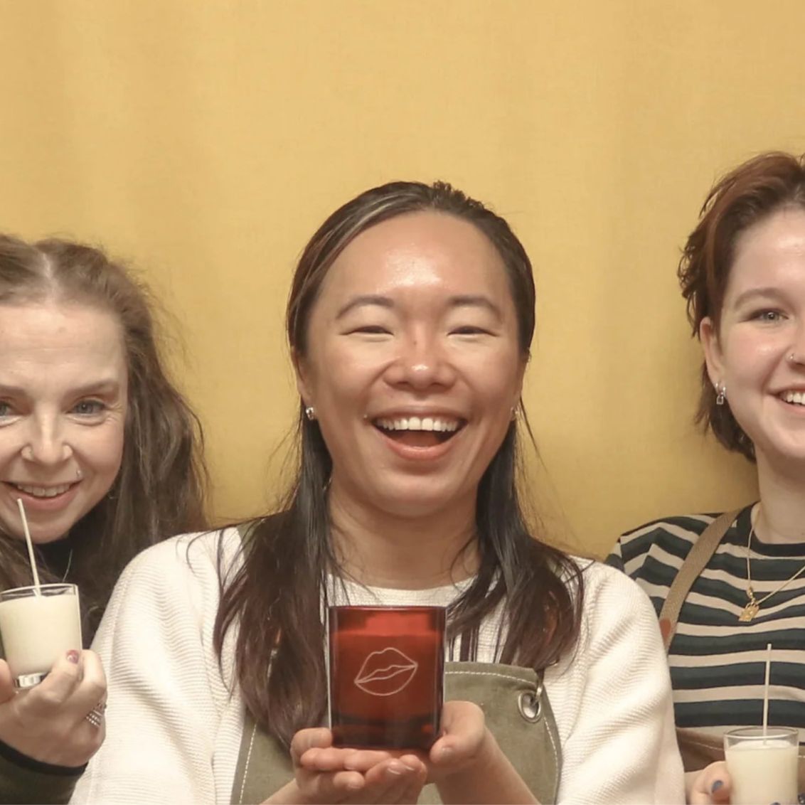 Group of people at a candle making workshop with text overlay.