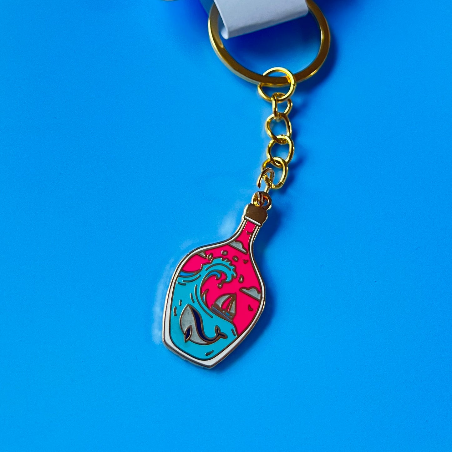 Foxti illustrated keyring with gold-plated chain on premium recycled card packaging
