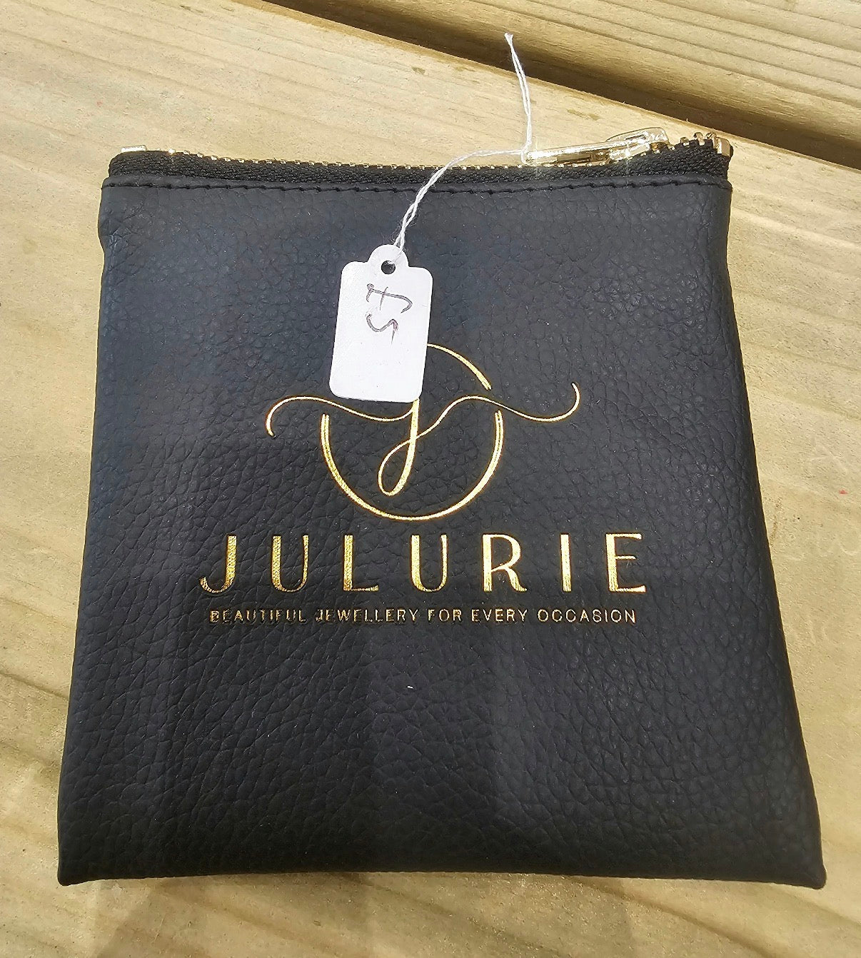 Julurie black textured leather jewellery wallet with gold detailing and zip closure